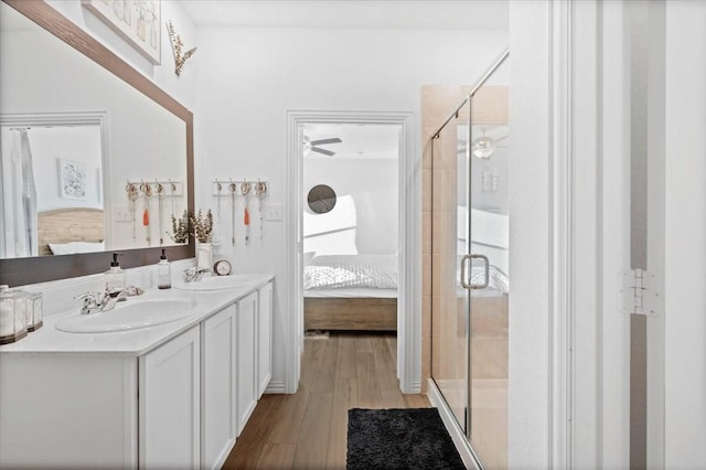 bathroom featuring vanity, wood-type flooring, and an enclosed shower