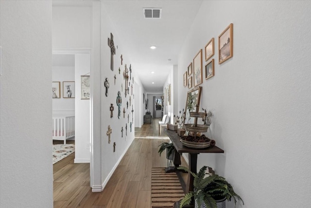 corridor with hardwood / wood-style floors