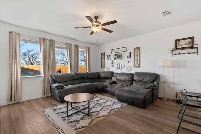 living room with ceiling fan and hardwood / wood-style floors