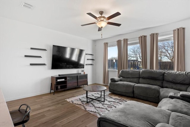 living room with ceiling fan and dark hardwood / wood-style floors