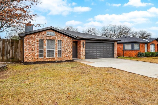 ranch-style home with a front lawn and a garage