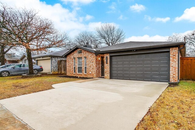 single story home featuring a front yard and a garage