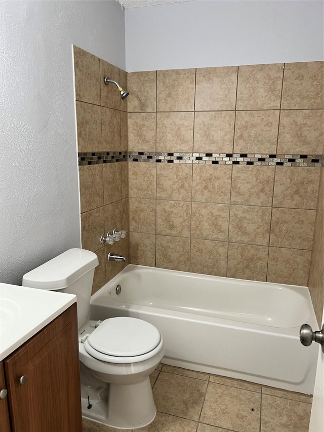 full bathroom with tile patterned flooring, vanity, toilet, and tiled shower / bath combo