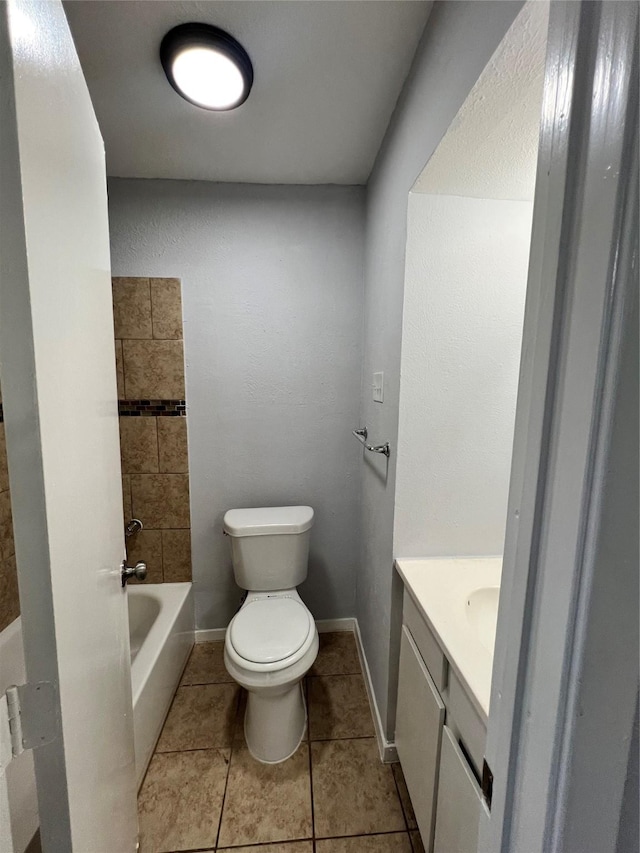 bathroom with tile patterned flooring, vanity, and toilet