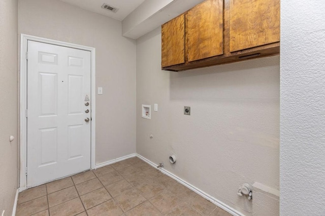 5400 Belle Chasse Ln, Frisco, TX 75035 - washroom featuring gas dryer hookup, cabinet space, washer hookup, light tile patterned floors, and electric dryer hookup