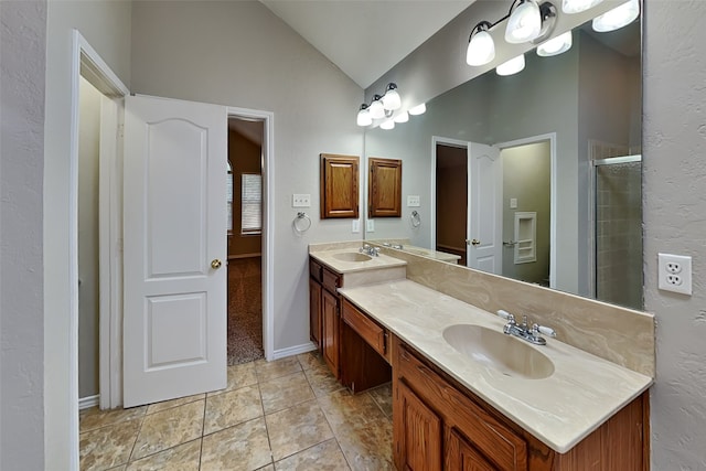 bathroom with vanity, a shower with door, and lofted ceiling