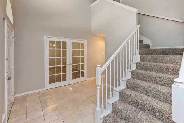 5400 Belle Chasse Ln, Frisco, TX 75035 - stairs with french doors, a high ceiling, and baseboards