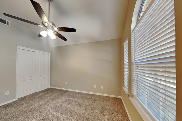 unfurnished bedroom with ceiling fan, carpet, and vaulted ceiling