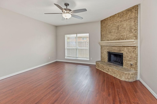 5400 Belle Chasse Ln, Frisco, TX 75035 - unfurnished living room with dark wood finished floors, a ceiling fan, baseboards, and a fireplace