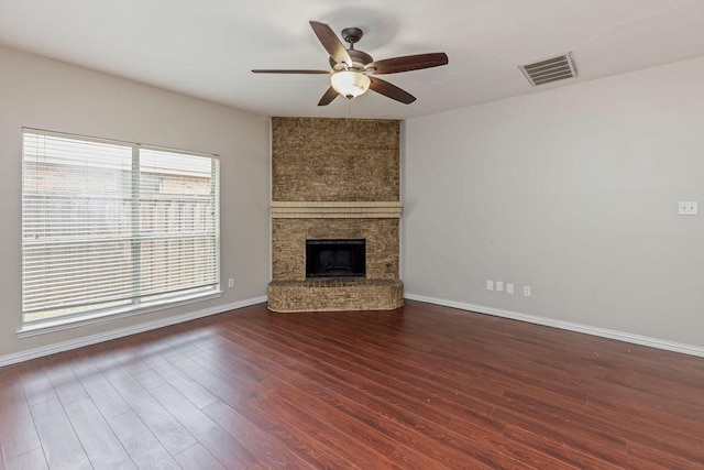 5400 Belle Chasse Ln, Frisco, TX 75035 - unfurnished living room with ceiling fan, wood finished floors, a large fireplace, and baseboards