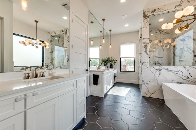 bathroom featuring independent shower and bath, vanity, tile patterned floors, and an inviting chandelier