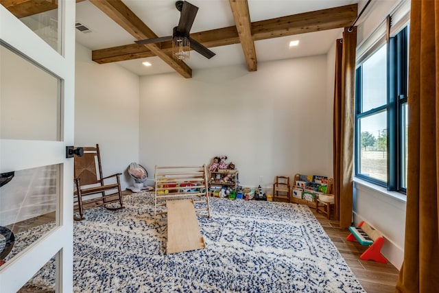 recreation room with ceiling fan, beamed ceiling, and coffered ceiling