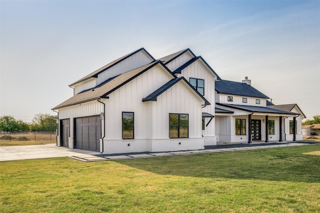 back of property with a garage and a yard