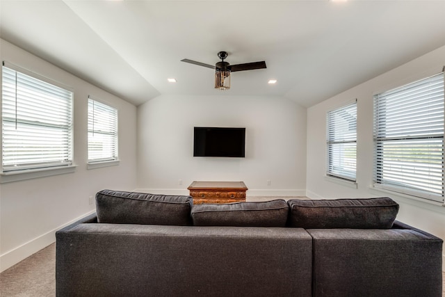 living room featuring carpet flooring, ceiling fan, and lofted ceiling