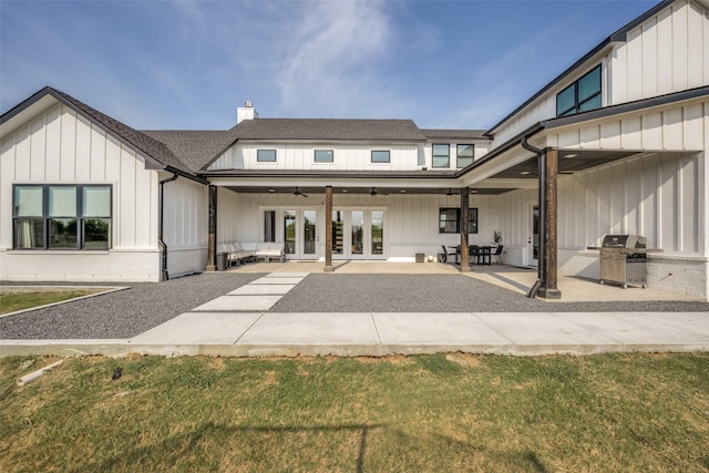 back of property featuring a lawn, french doors, ceiling fan, a patio area, and exterior kitchen