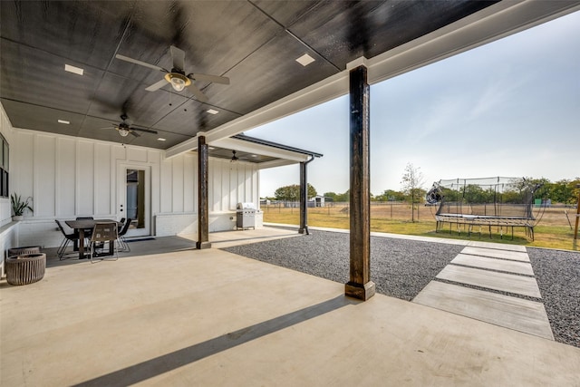 view of patio / terrace with a grill, ceiling fan, and a trampoline