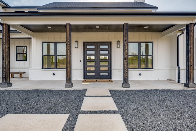 view of exterior entry with a porch