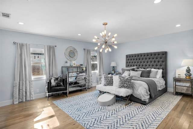 bedroom with hardwood / wood-style flooring and a notable chandelier