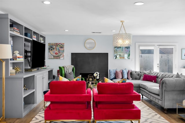 living room with light wood-type flooring and french doors