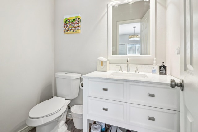 bathroom featuring vanity, toilet, and hardwood / wood-style floors