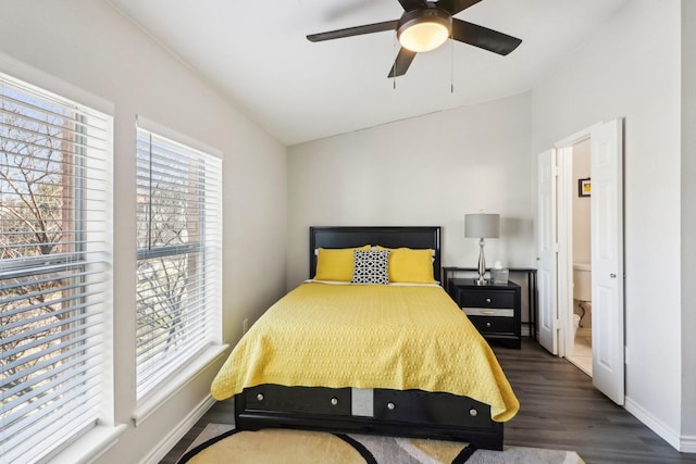 bedroom featuring ceiling fan, dark wood-type flooring, multiple windows, and lofted ceiling