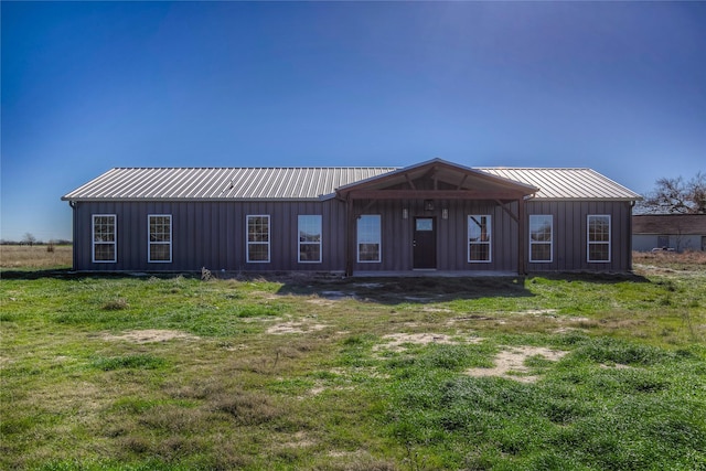 back of property featuring a yard