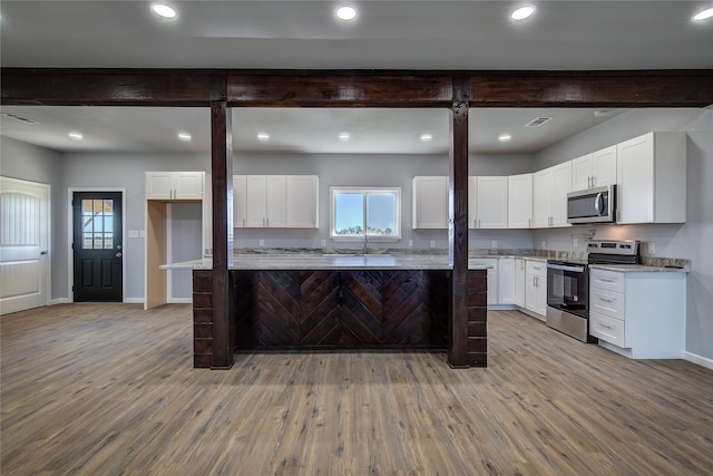 kitchen featuring white cabinetry, light hardwood / wood-style flooring, and stainless steel appliances