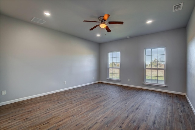 spare room with ceiling fan and dark wood-type flooring