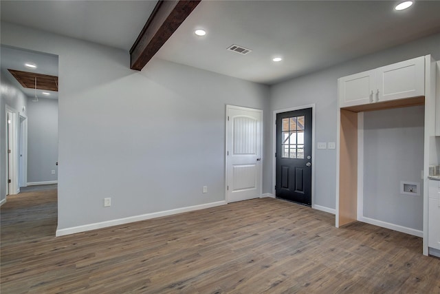 entrance foyer featuring light hardwood / wood-style flooring and beamed ceiling