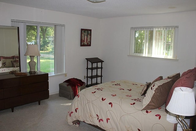 carpeted bedroom featuring a textured ceiling