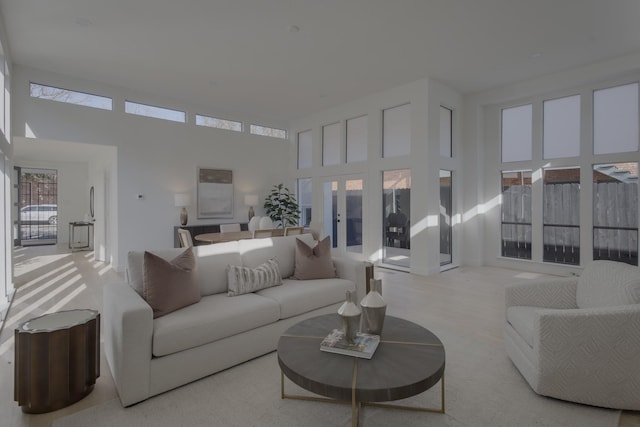 living room featuring a high ceiling and french doors