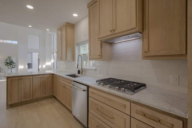 kitchen featuring light brown cabinets, sink, light hardwood / wood-style flooring, decorative backsplash, and appliances with stainless steel finishes