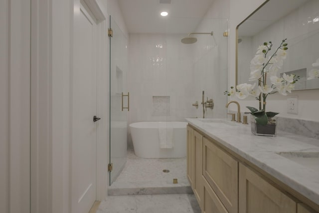 bathroom with vanity, independent shower and bath, and an inviting chandelier