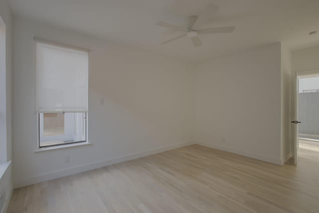 spare room featuring light wood-type flooring and ceiling fan