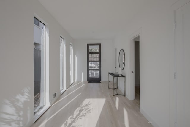 hallway featuring french doors and light hardwood / wood-style flooring