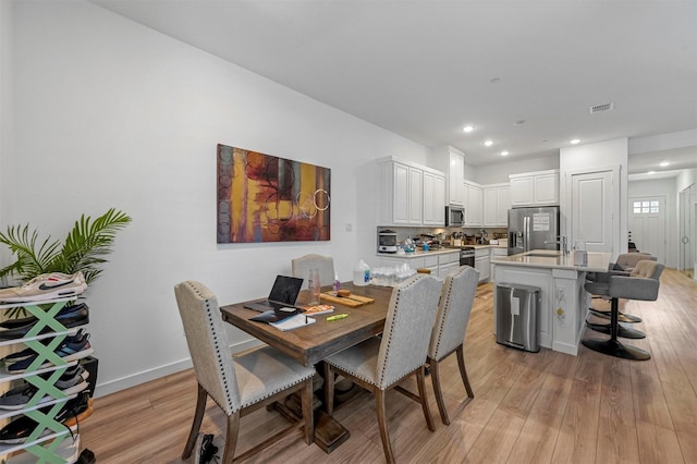 dining area featuring light hardwood / wood-style flooring