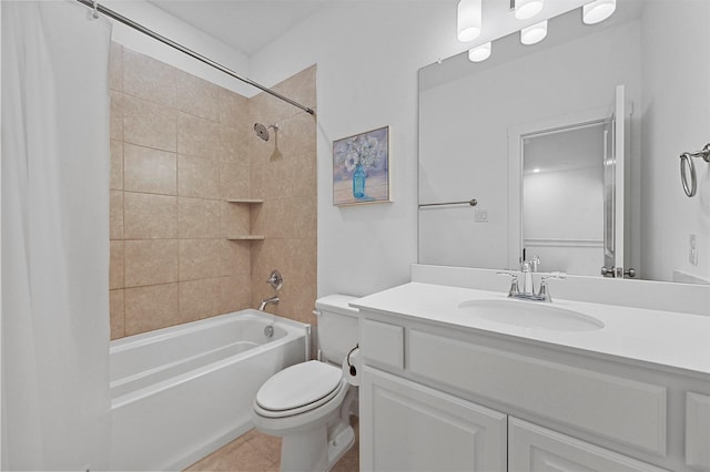 full bathroom featuring tile patterned floors, toilet, vanity, and tiled shower / bath