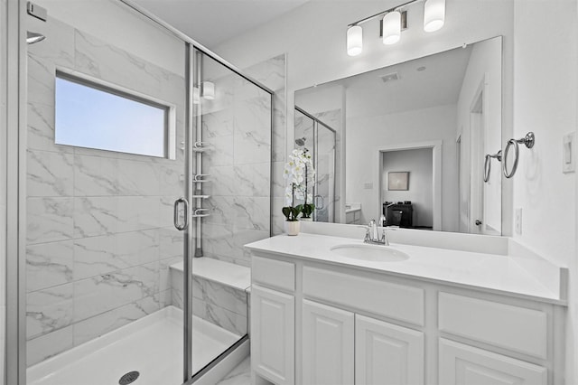 bathroom with a shower with door and vanity