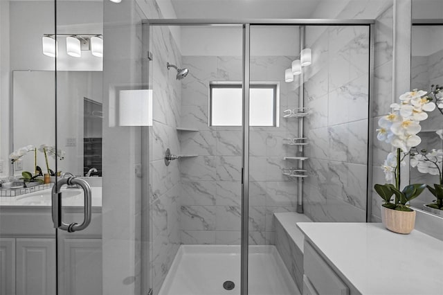 bathroom featuring vanity and a shower with door