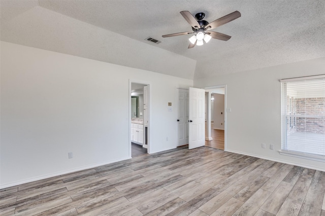 interior space featuring ceiling fan, light hardwood / wood-style flooring, and a textured ceiling