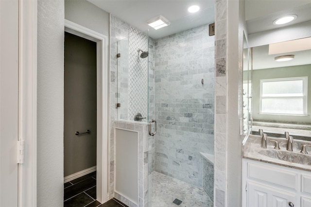 bathroom with vanity and a shower with shower door