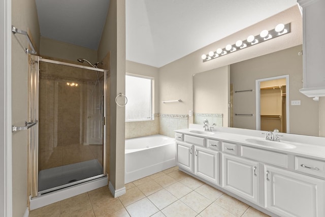 bathroom with vanity, tile patterned flooring, and plus walk in shower