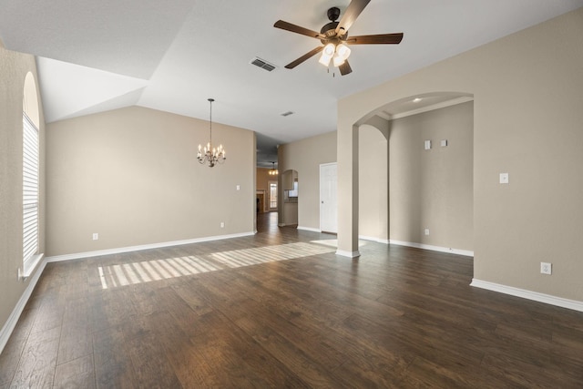 unfurnished living room featuring plenty of natural light, dark hardwood / wood-style floors, ceiling fan with notable chandelier, and vaulted ceiling