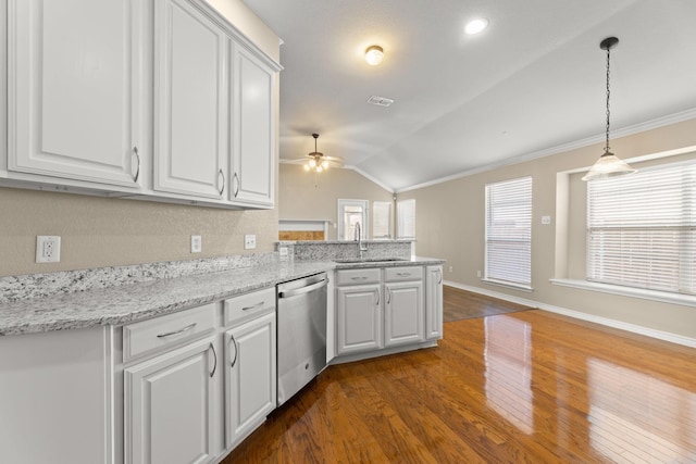 kitchen with dishwasher, lofted ceiling, kitchen peninsula, ceiling fan, and white cabinetry