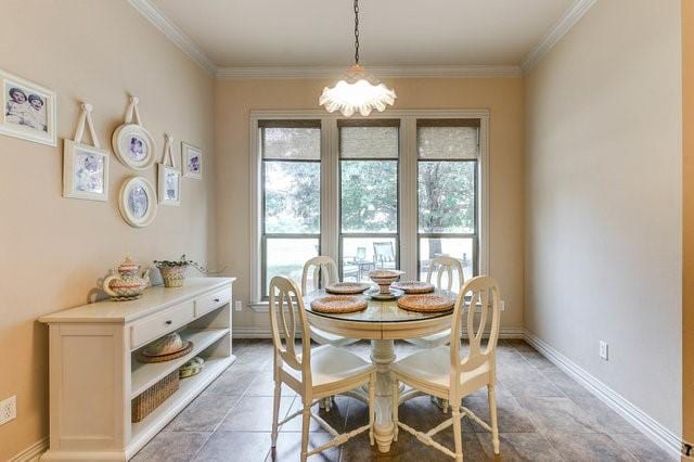 dining space featuring ornamental molding and an inviting chandelier