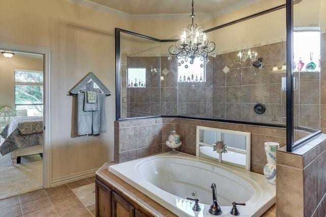 bathroom featuring tile patterned floors, ornamental molding, tiled bath, and a chandelier