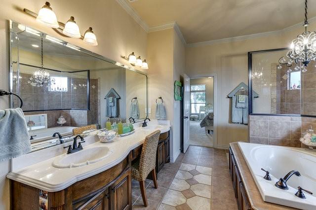 bathroom with vanity, a notable chandelier, plenty of natural light, and ornamental molding