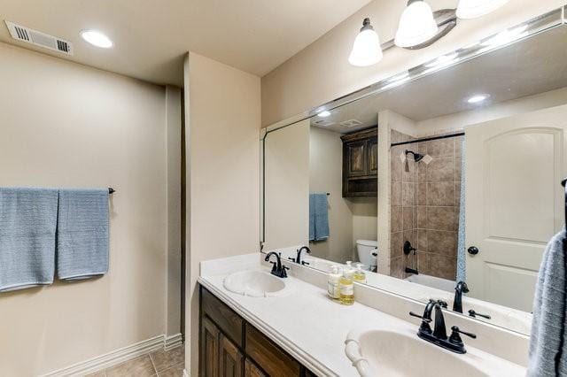 bathroom with vanity, tile patterned flooring, and toilet