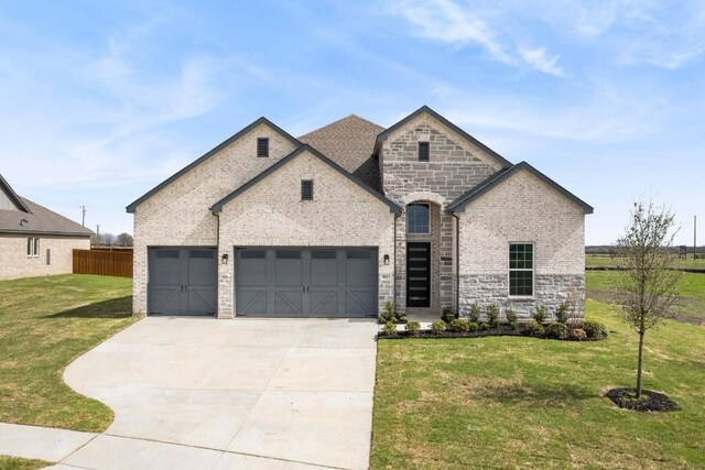 view of front of home featuring a yard and a garage