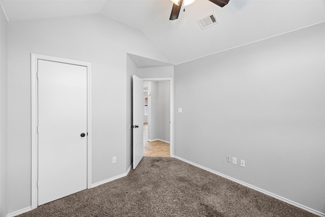 unfurnished bedroom with light carpet, vaulted ceiling, and ceiling fan